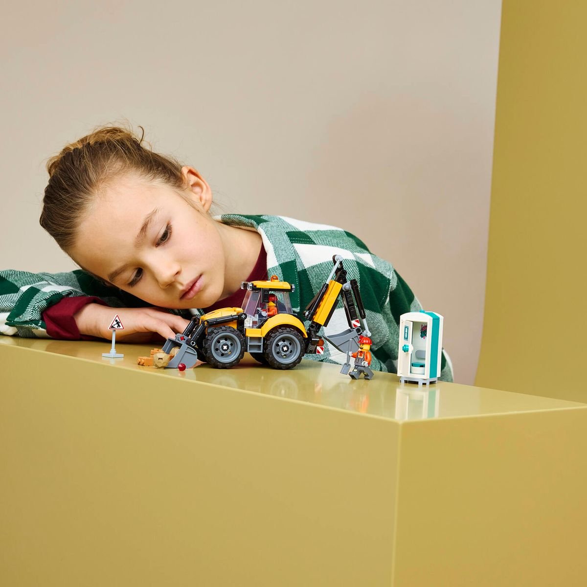 LEGO 60480 Yellow Backhoe Loader displayed alongside other LEGO City construction sets